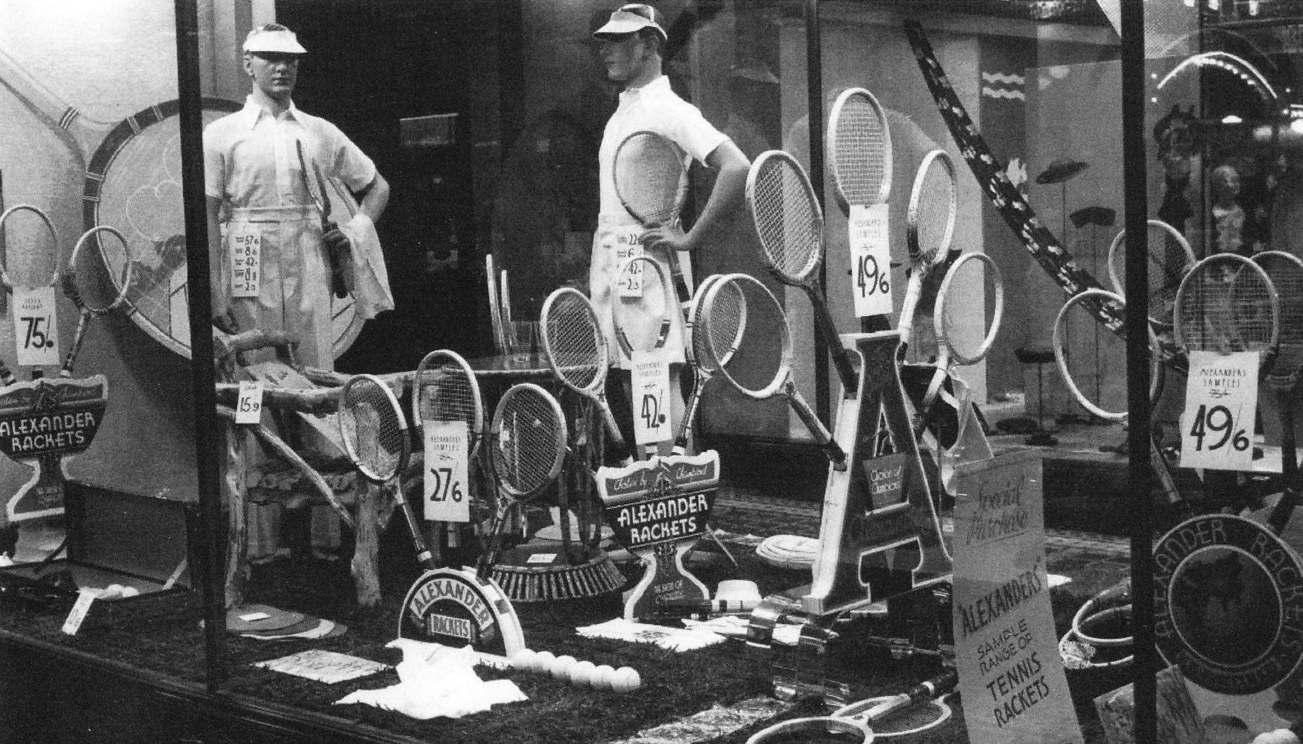 A historical photo showing a tennis racquet window display of Alexander Patent Racket Company
