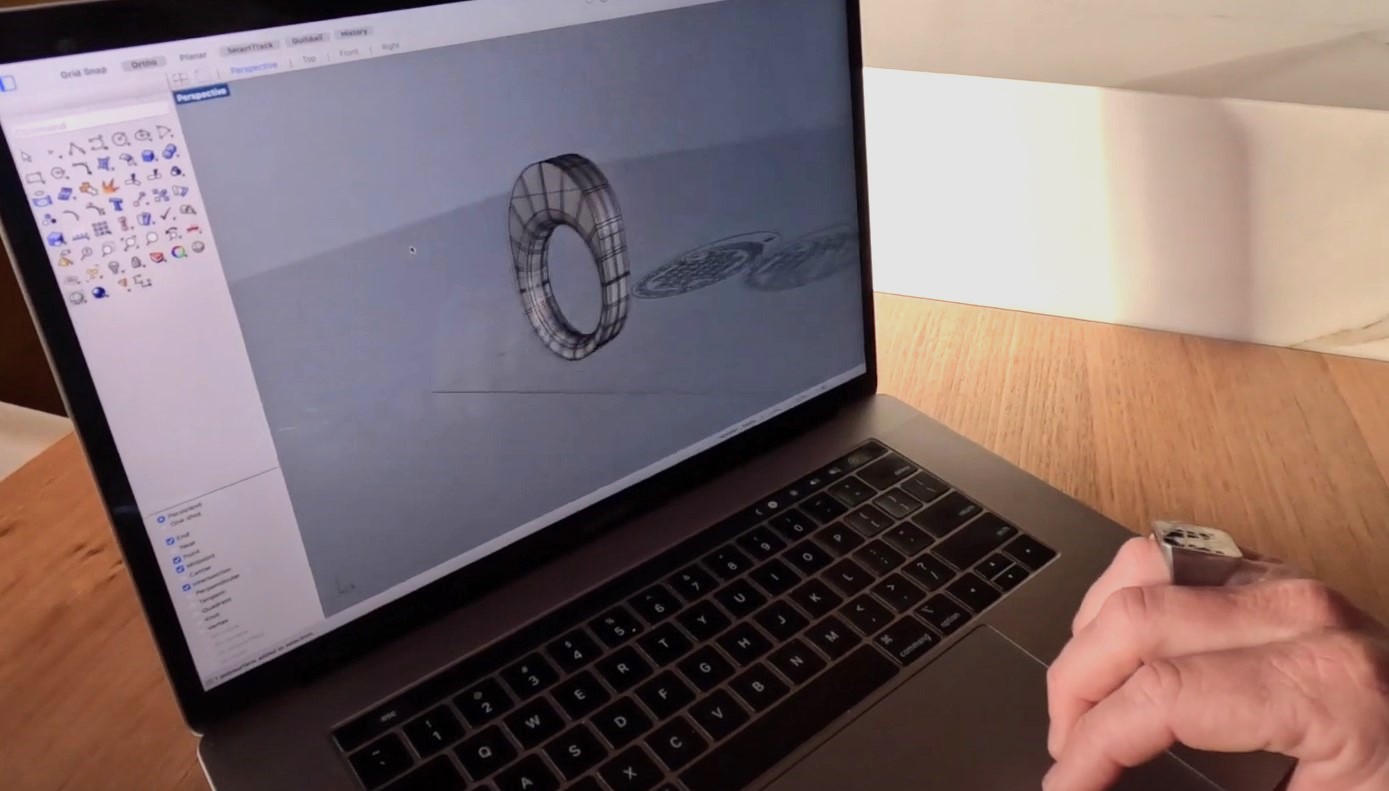 CAD Jeweller Carl Noonan demonstrates a 3D render of a ring design on his laptop