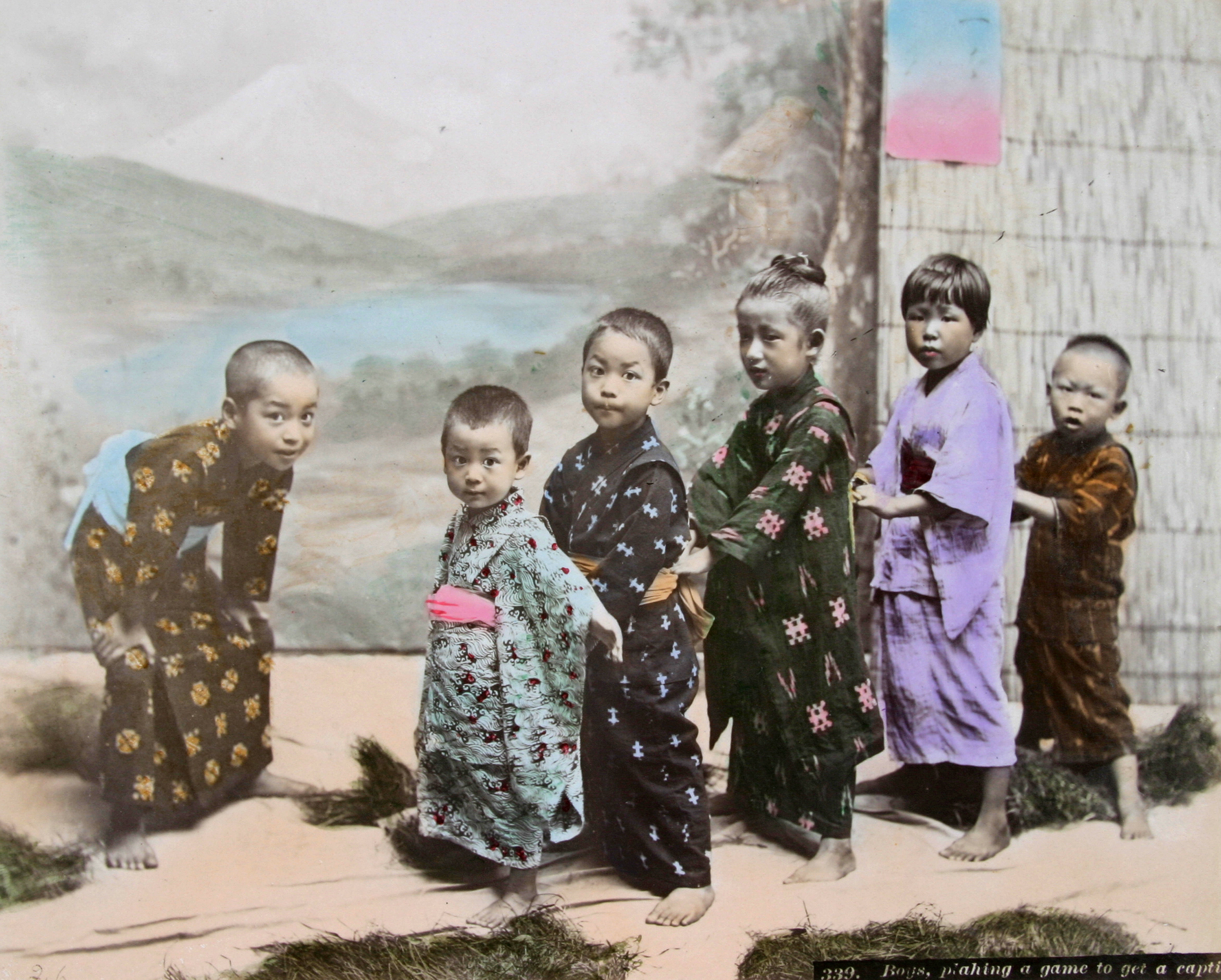 An old photograph showing Japanese boys playing a game to get a captive