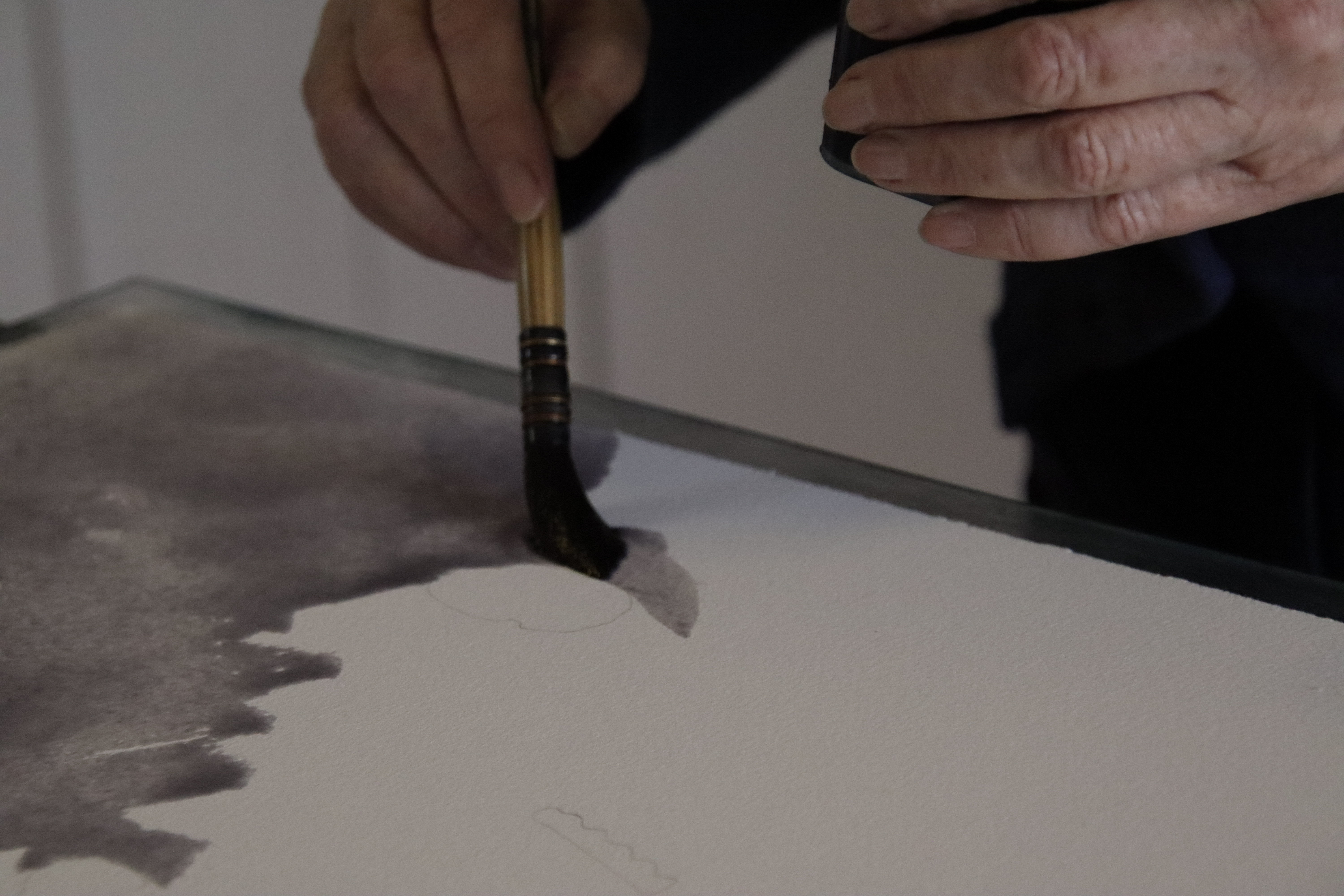 Image: first layer of paint being applied leaving details as negative spaces. 