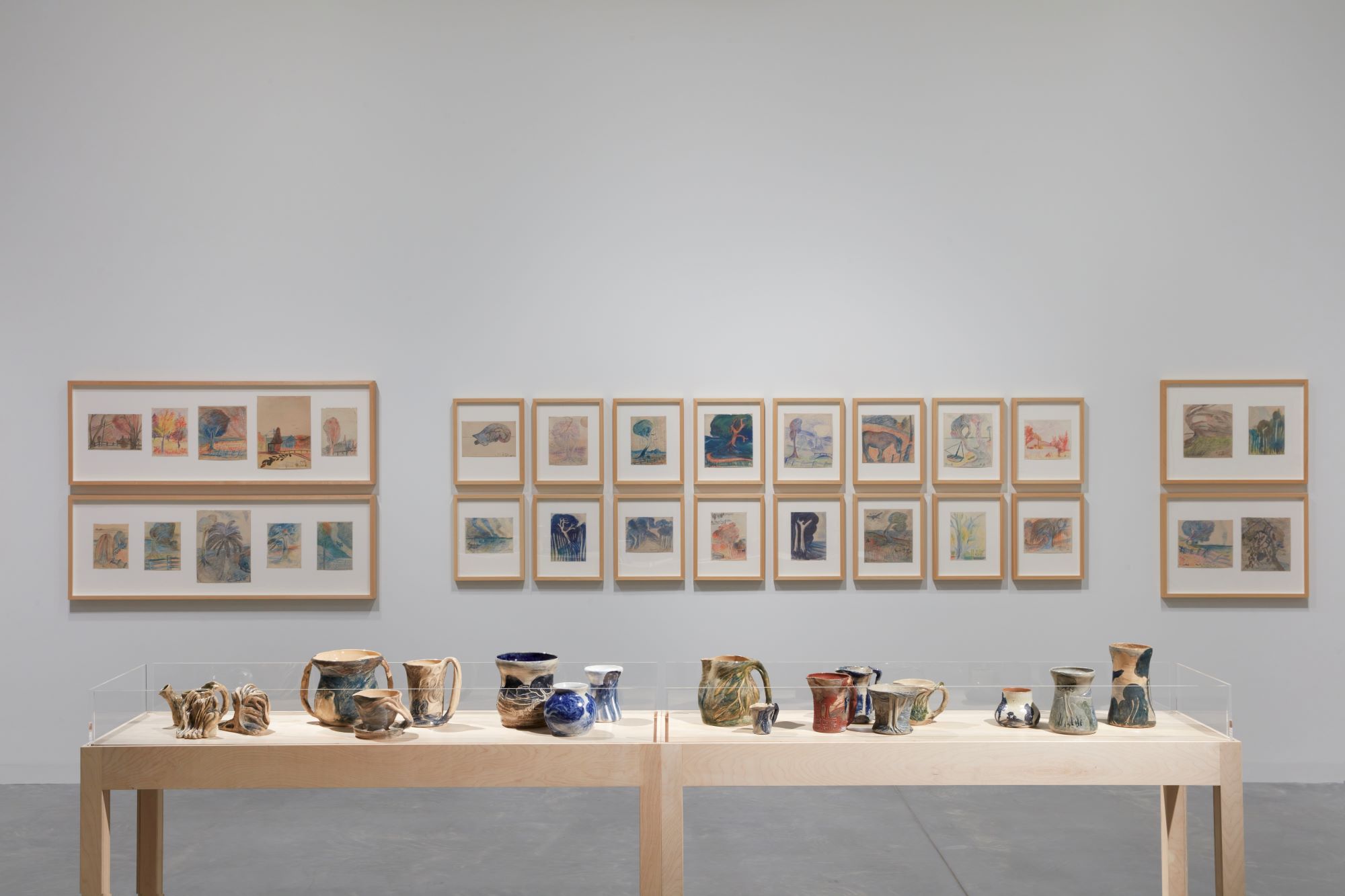 Installation view of drawings and ceramics by artist Merric Boyd.