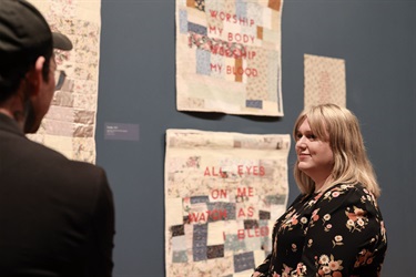 Artist Clara Martin with her artwork in RISE