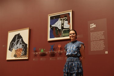 Artist Eloise Lark with her work featured in RISE