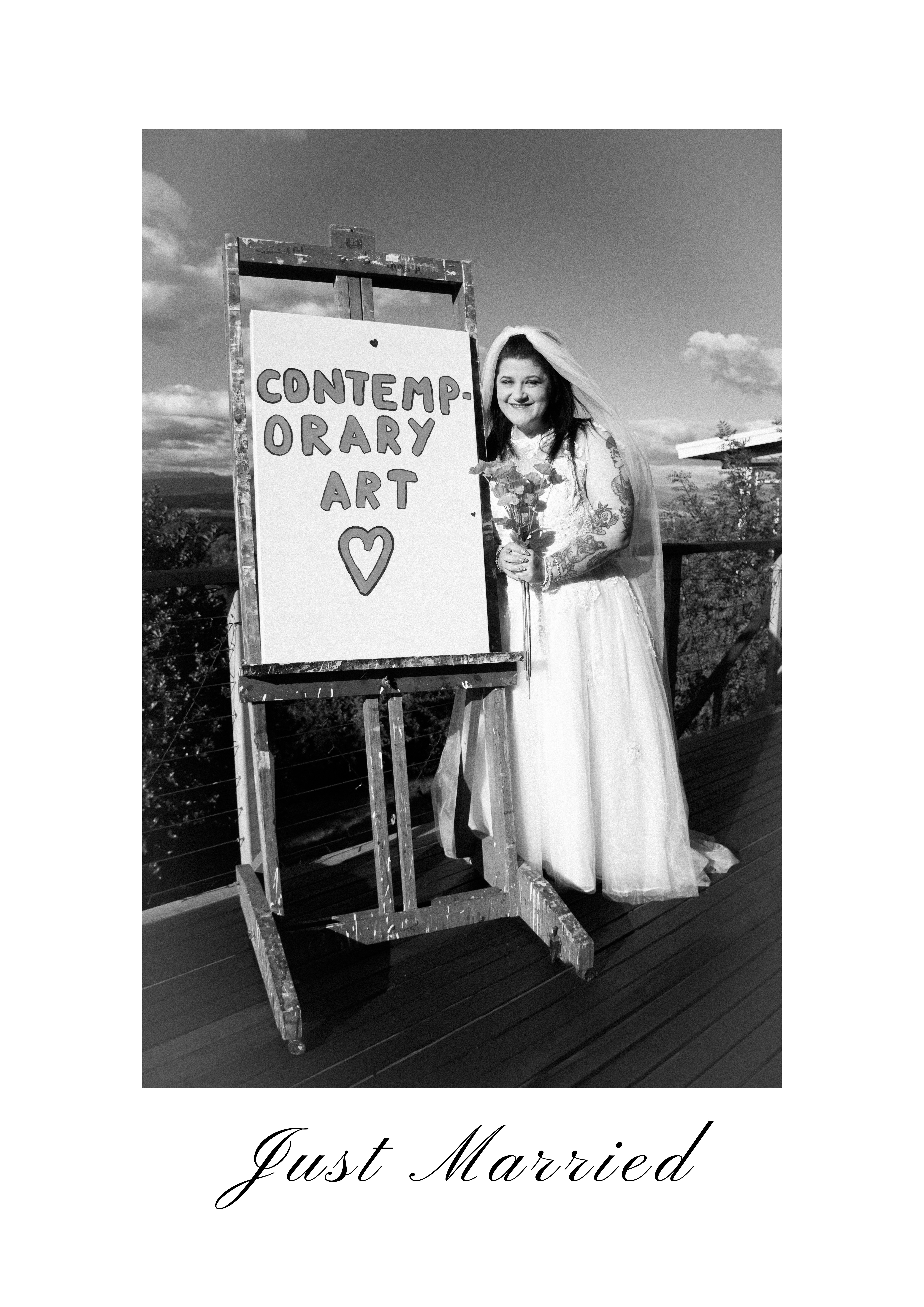 A photographic artwork of a female in a wedding dress next to a sign saying 