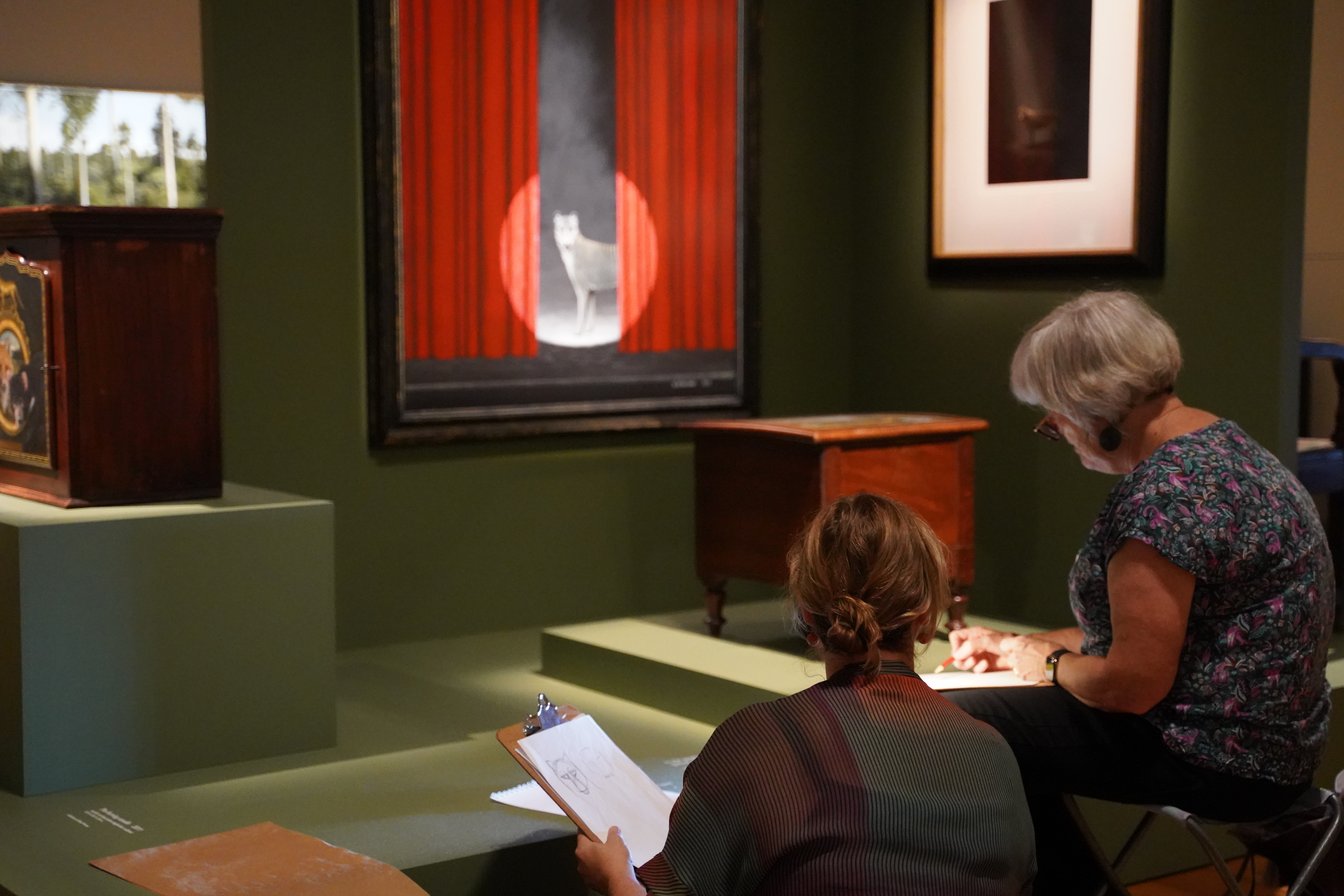 Artist Manuela Pilz and workshop participant, sketching in front of a painting in the Gentle Protagonist exhibition.