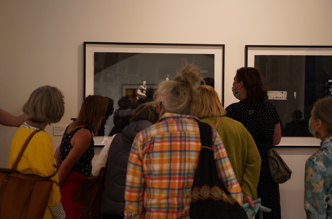 Women exploring works within the exhibition Herself at QVMAG