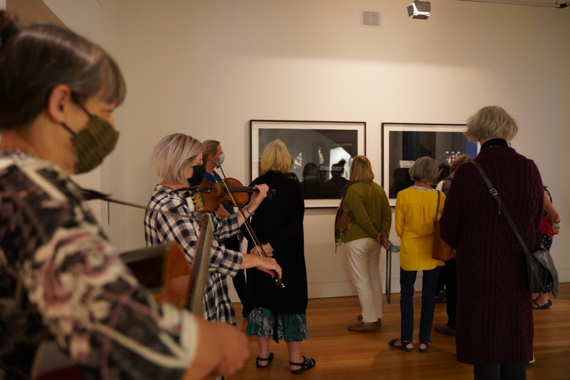 Women walking through the exhibition, Herself, on International Women's Day 