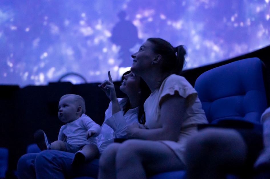 Families in the Planetarium.JPG